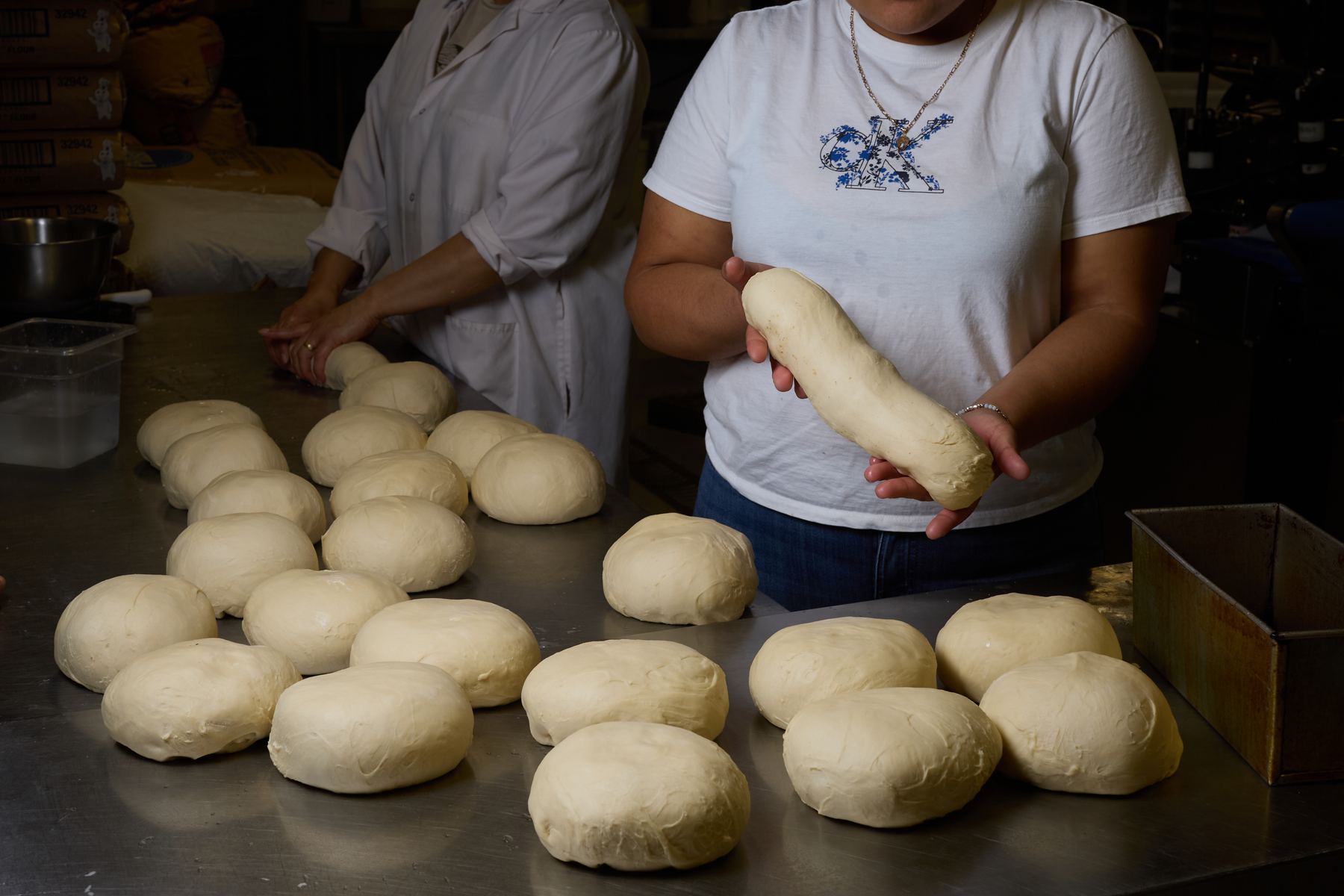 Bakers shaping dough by hand