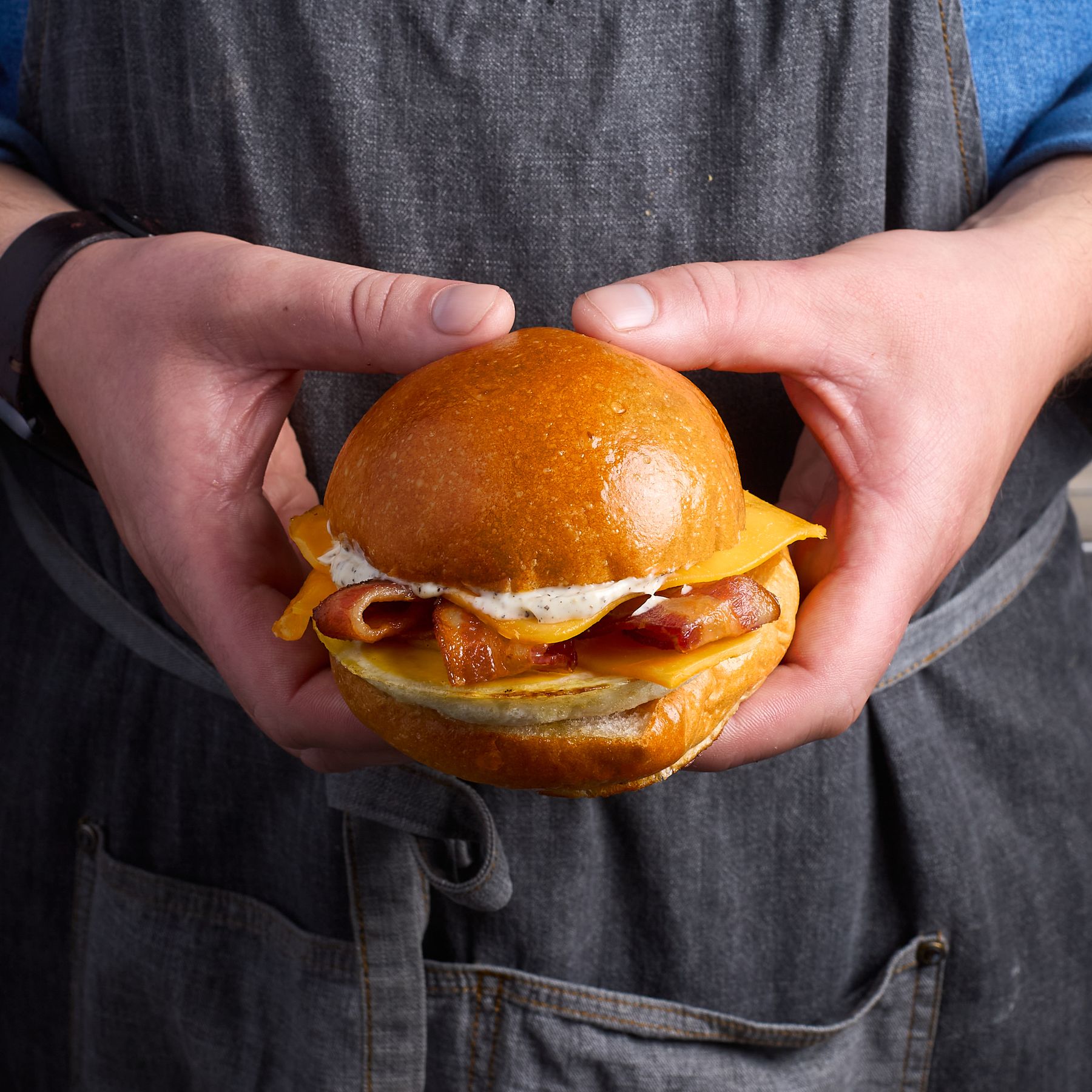 Bacon egg and cheese breakfast sandwich on house-made milk bread bun